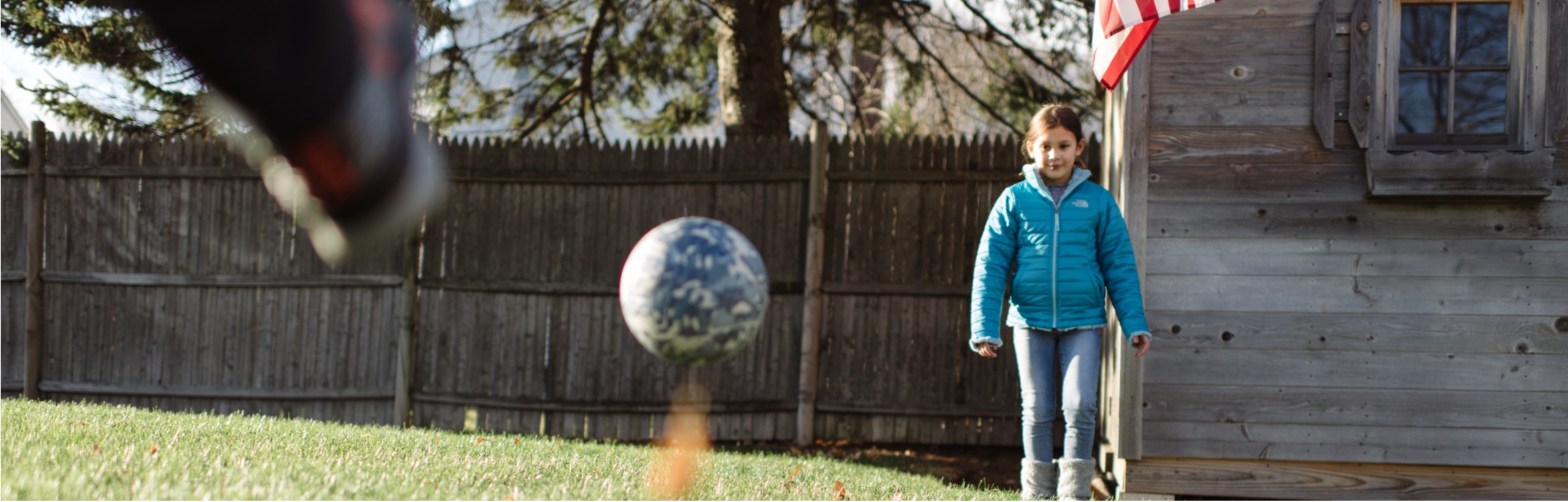 Kids playing soccer in their backyard