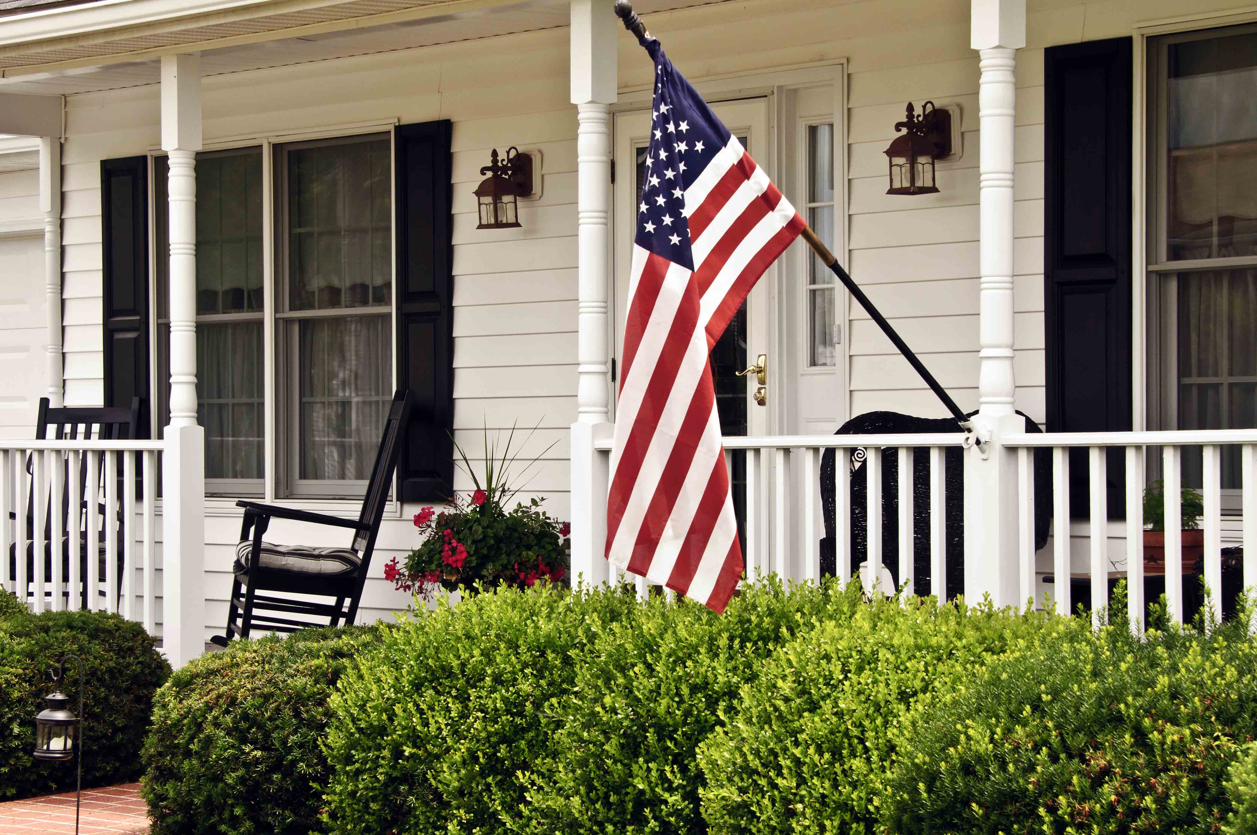 Home porch with an American flag