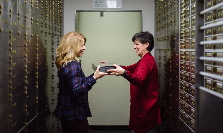A WSB personal banker giving a customer her safe deposit box.