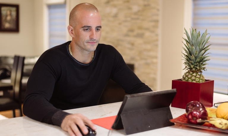 Customer working from home on his laptop.