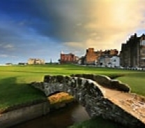 Scotland landscape of a field and an old castle and village in the background.