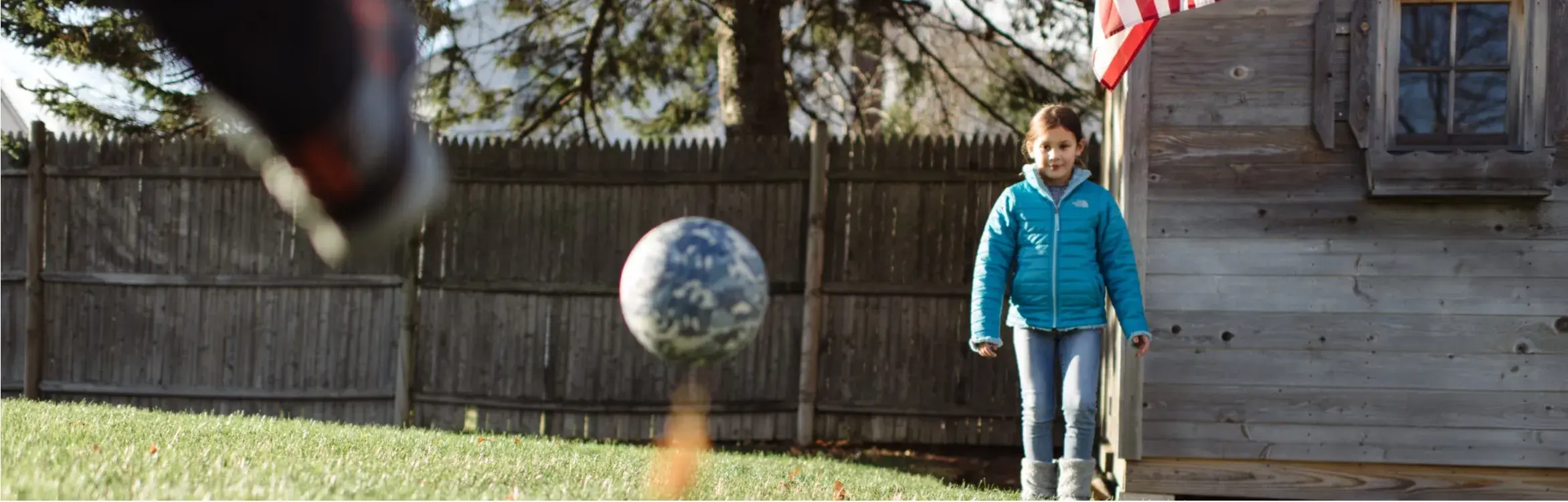 Kids playing soccer in their backyard