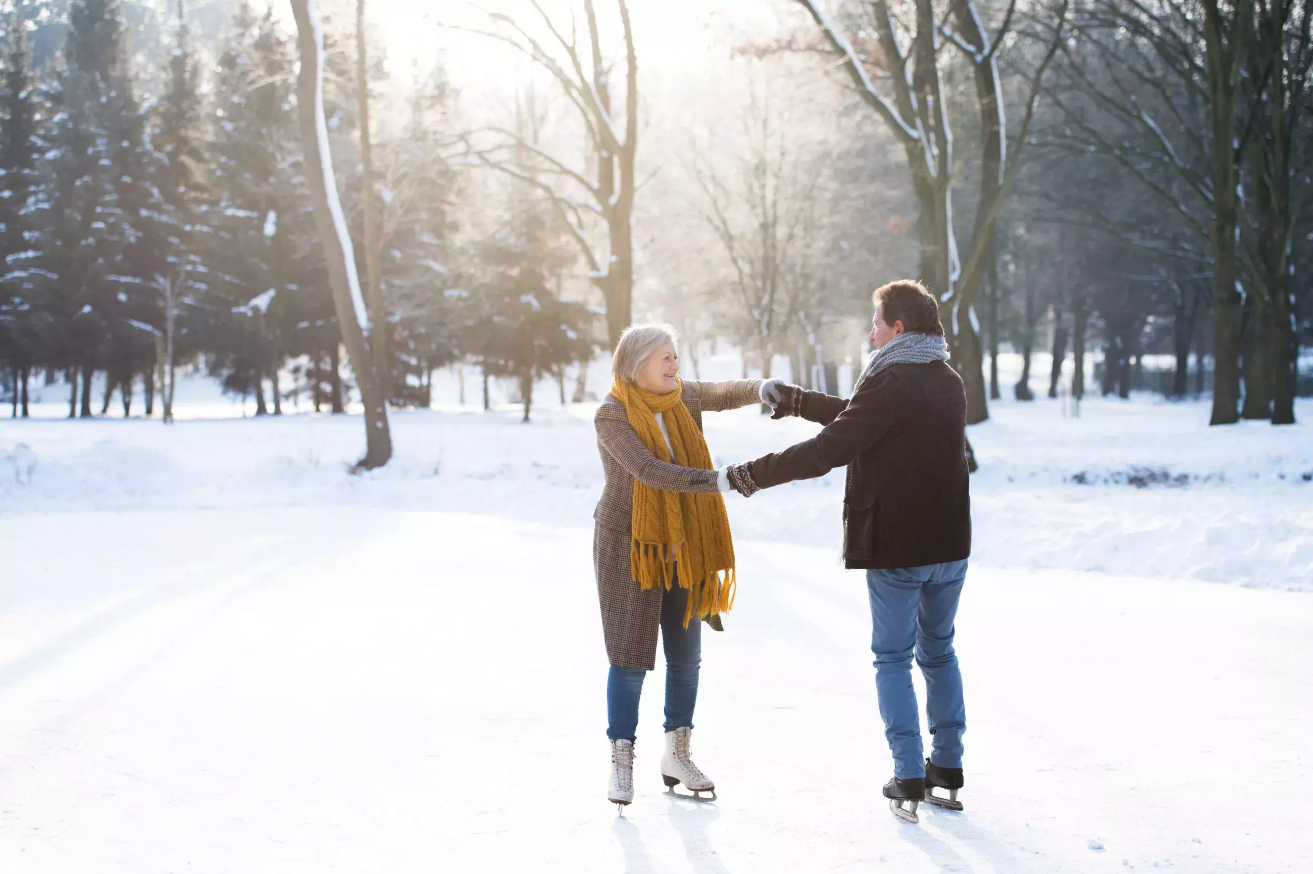 Couple holding hands while skating