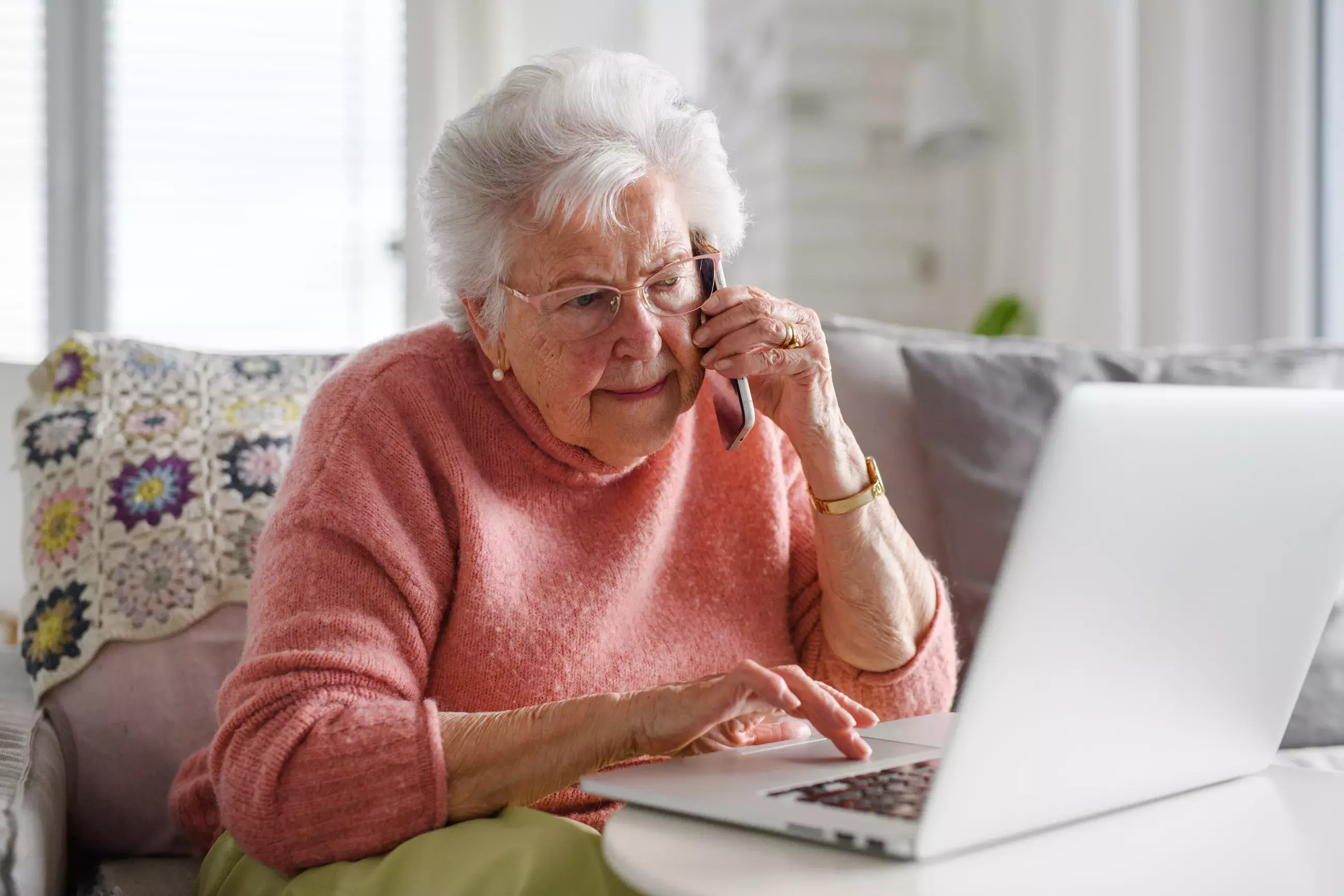 Older woman on the phone and laptop