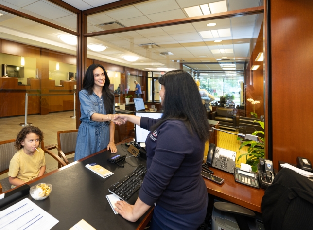 Customer and Personal Banker shaking hands.