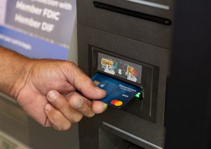 Customer using their WSB debit card at an ATM machine.