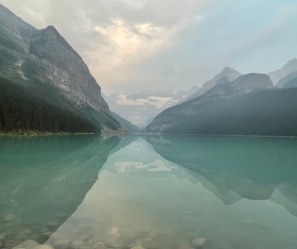 Blue and teal lake surrounded by mountains in Alberta, Canada