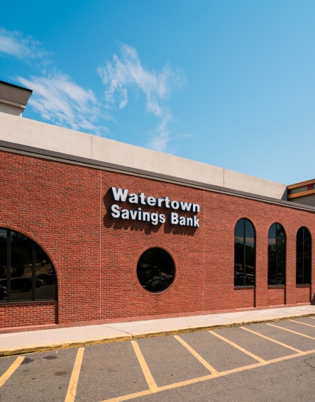 Brick building with the Watertown Savings Bank name and entrance to the supermarket.