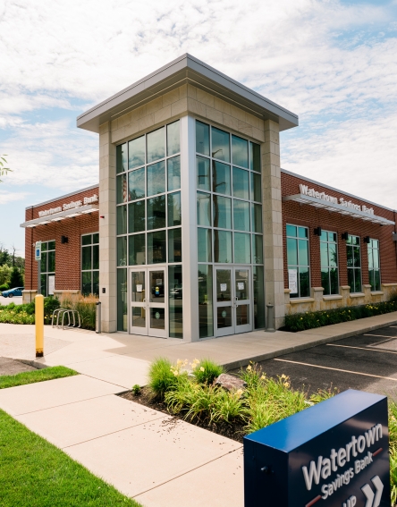 The front of the WSB Market Basket Plaza Branch with large glass entrance walls.