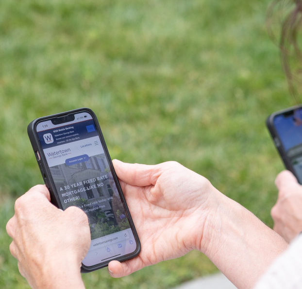 Parents checking their WSB accounts on their WSB Mobile Banking apps.