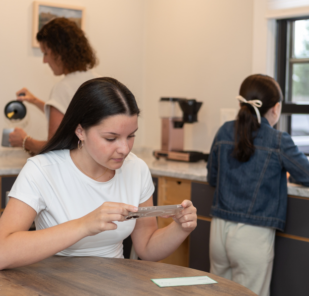 Young woman depositing a check to her WSB account using her phone.